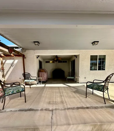 a living room with chairs and a fireplace