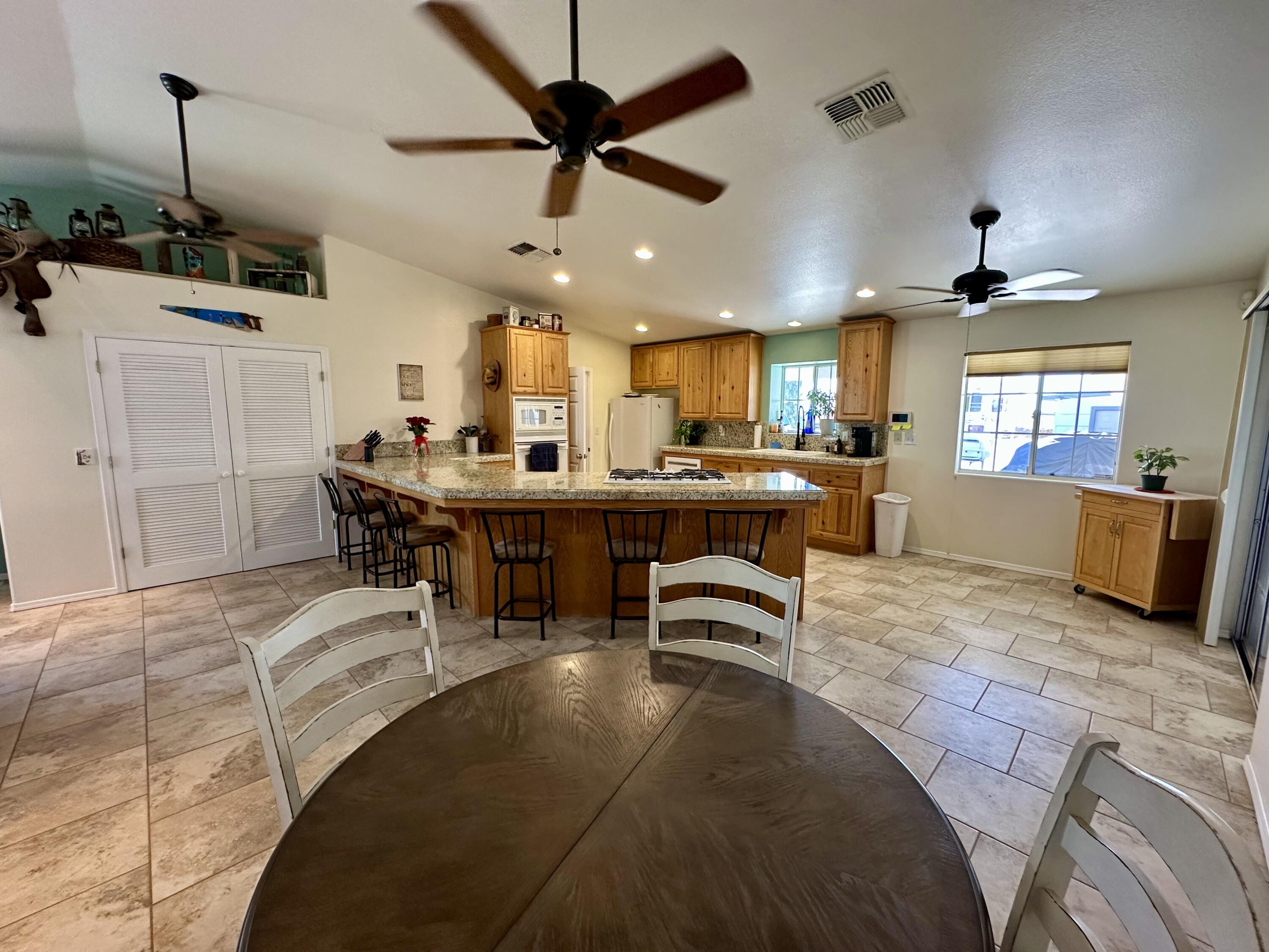 1731 Riviera Drive Blythe, CA 92225 - Photo 7 of 36 a living room with stainless steel appliances kitchen island granite countertop furniture and a view of kitchen