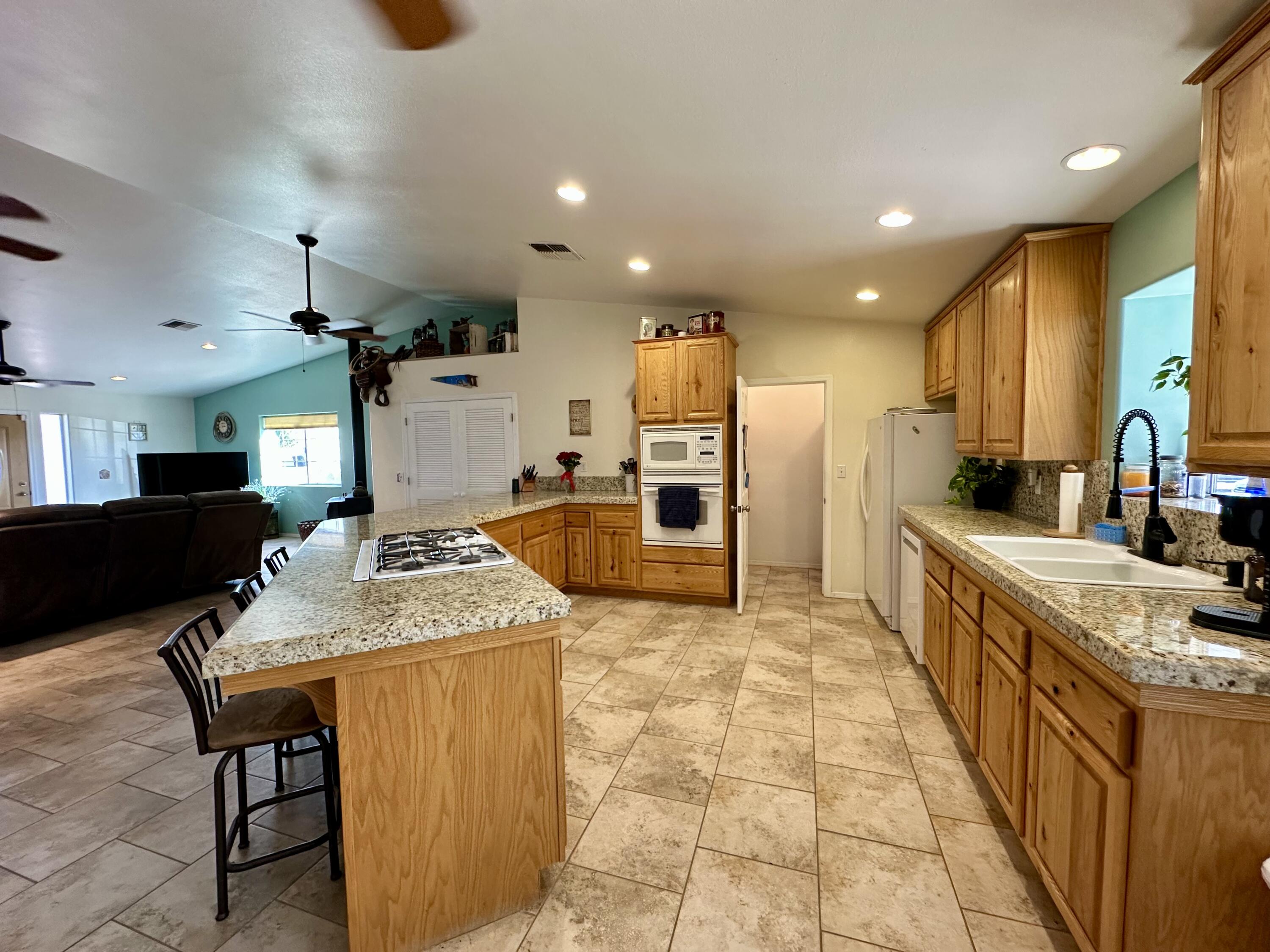 1731 Riviera Drive Blythe, CA 92225 - Photo 8 of 36 a large kitchen with kitchen island a stove a sink a oven and a dining table