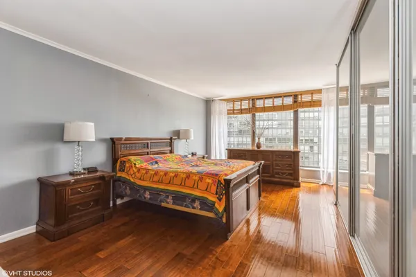 a bedroom with a bed and a large window