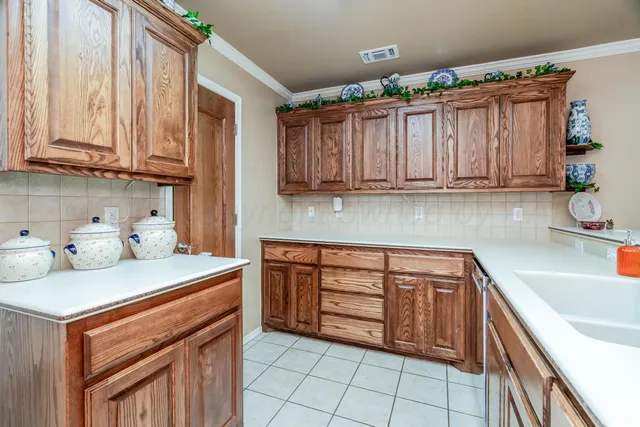 a kitchen with stainless steel appliances granite countertop a refrigerator a stove top oven a sink dishwasher and white cabinets with wooden floor