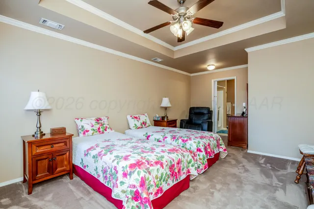 a bedroom with furniture and a chandelier