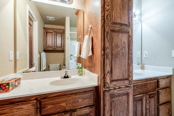 a bathroom with a granite countertop sink a mirror and a shower