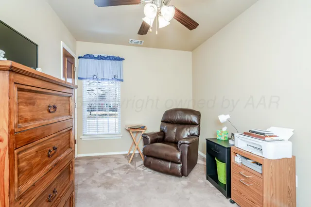 a view of a livingroom with furniture and a ceiling fan