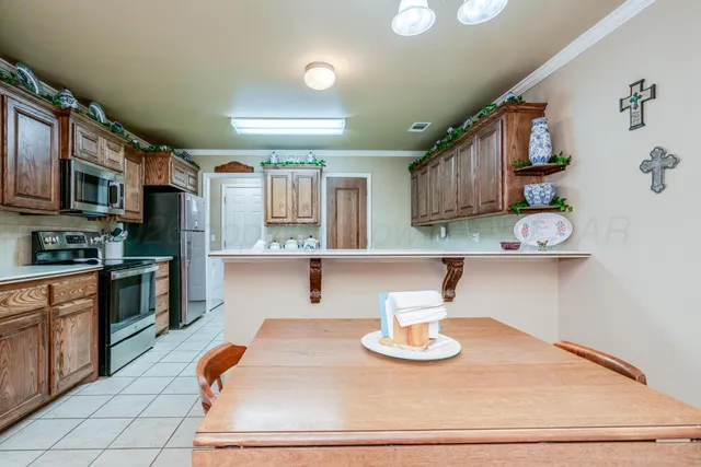 a kitchen with stainless steel appliances a stove a sink and a refrigerator