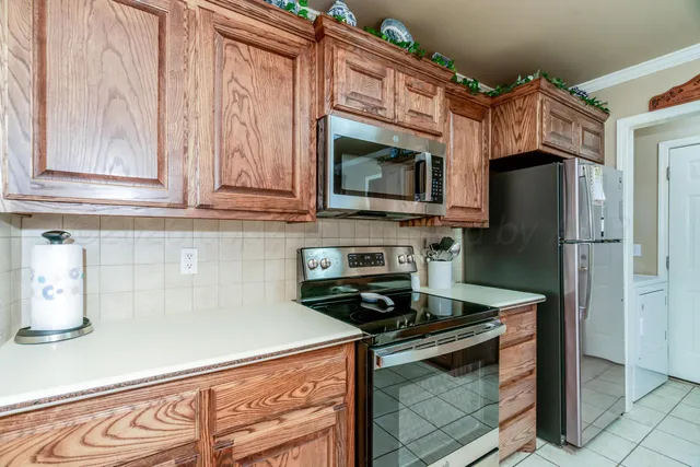 a kitchen with stainless steel appliances granite countertop a sink stove and cabinets