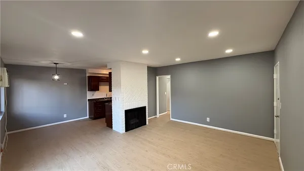 a view of an empty room with a fireplace