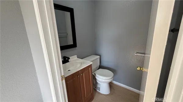 a white toilet sitting next to a bathroom sink