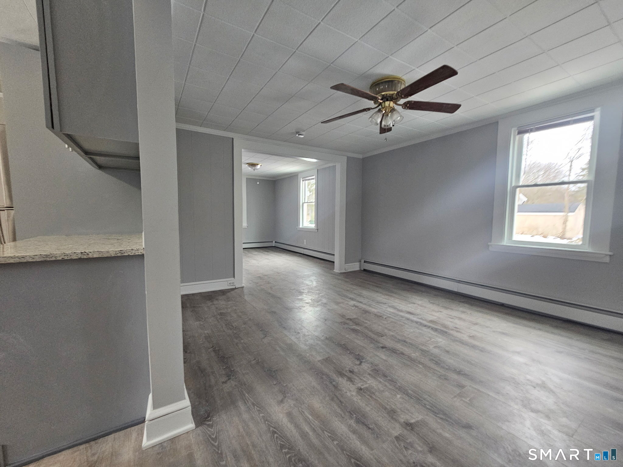 35 Morris Road Prospect, CT 06712 - Photo 4 of 19 an empty room with wooden floor a ceiling fan and windows