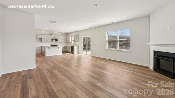 a view of a kitchen with furniture and wooden floor