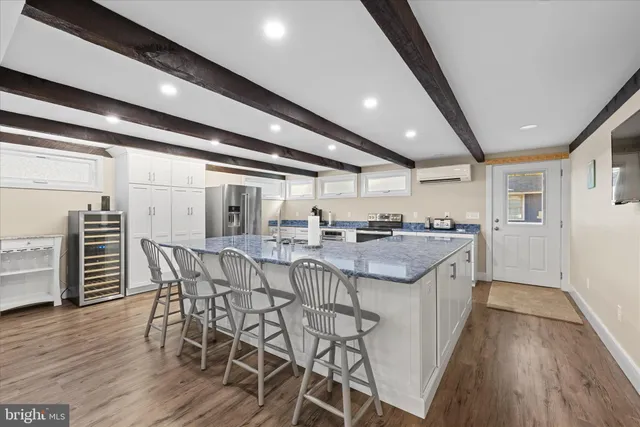 a kitchen with stainless steel appliances granite countertop a sink and stove