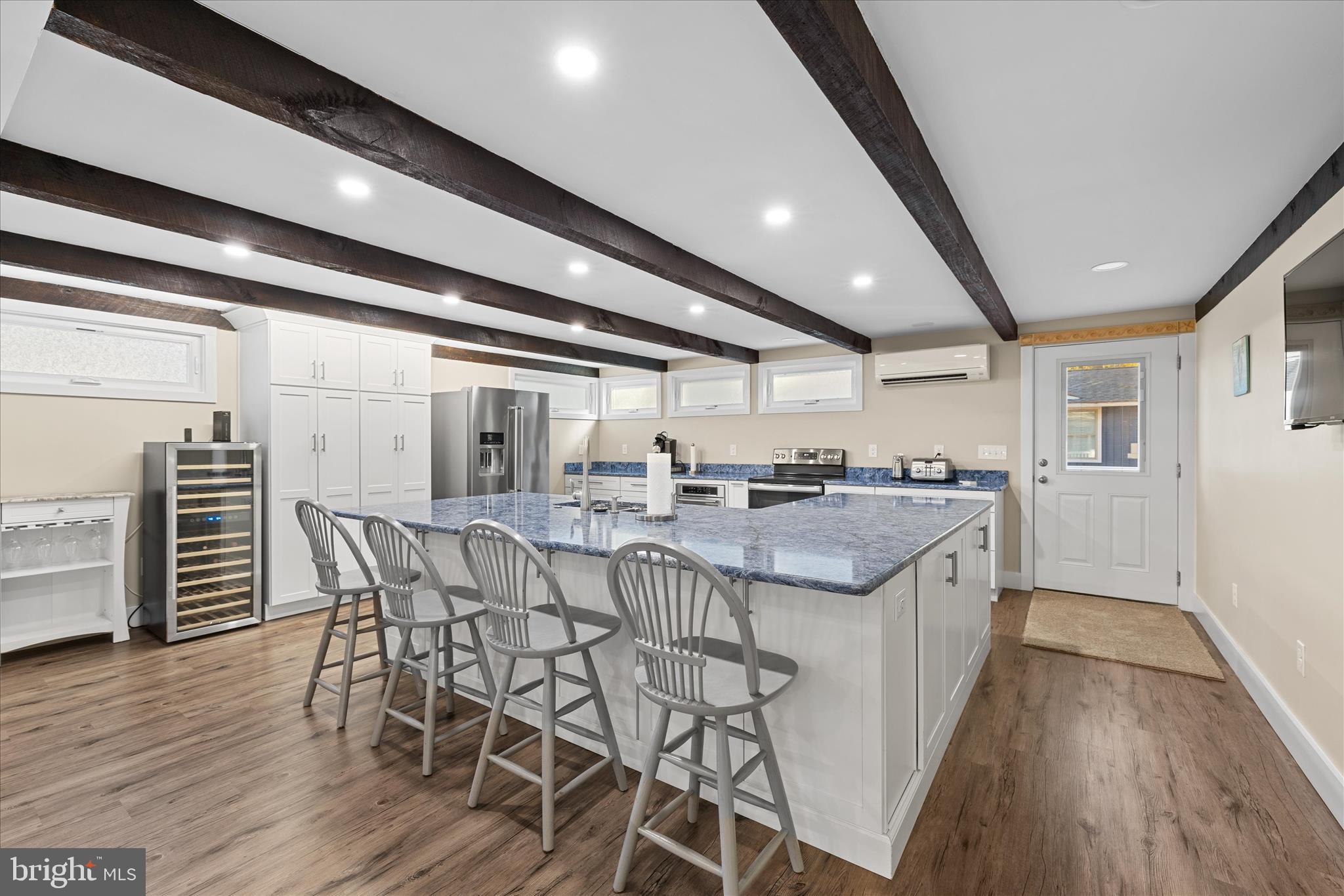 2 Bridge Road Bethany Beach, DE 19930 - Photo 15 of 65 a open kitchen with stainless steel appliances granite countertop a dining table chairs and granite counter tops