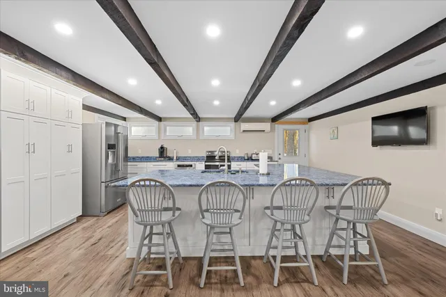 a kitchen with stainless steel appliances granite countertop a sink and refrigerator