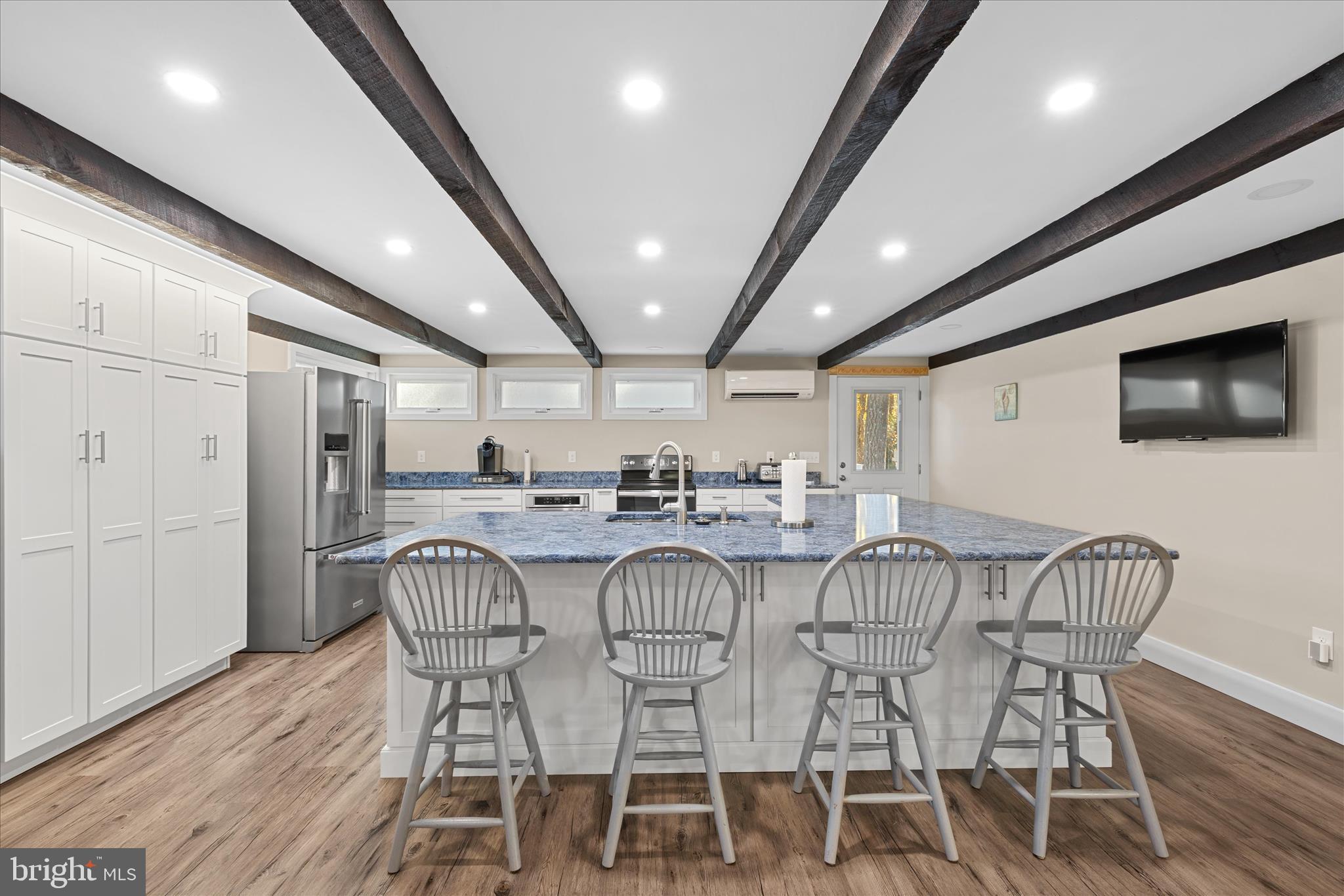 2 Bridge Road Bethany Beach, DE 19930 - Photo 16 of 65 a view of a dining room with furniture and wooden floor