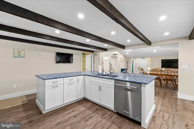 a bedroom with a large bed and wooden floor