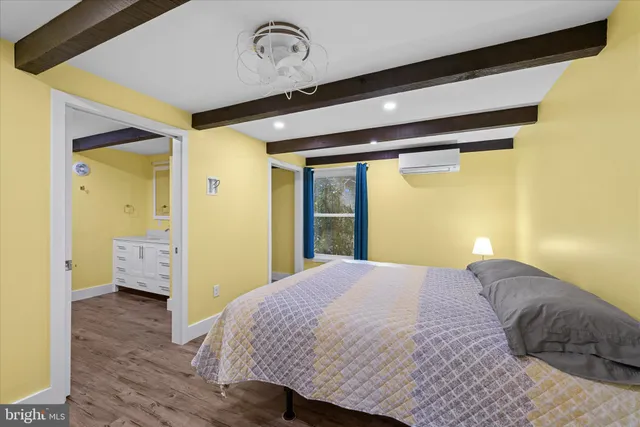 a bathroom with a granite countertop sink a mirror and shower