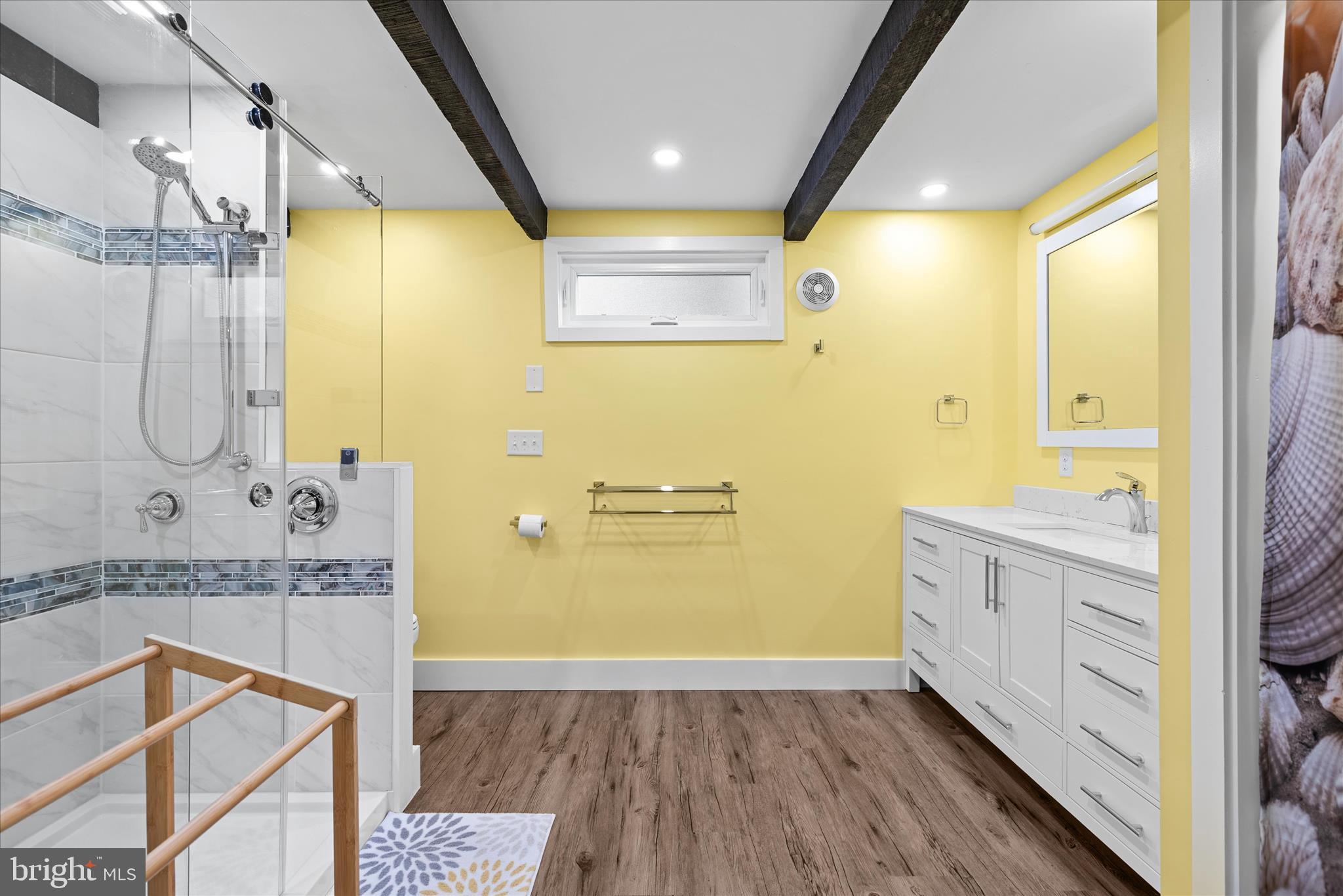 2 Bridge Road Bethany Beach, DE 19930 - Photo 22 of 65 a bathroom with a granite countertop sink a mirror a bathtub and shower