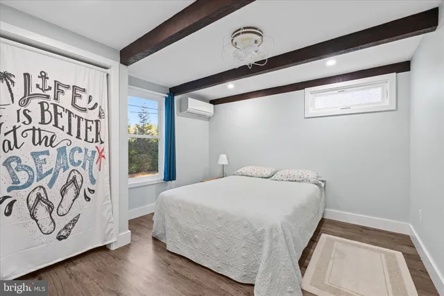 a bedroom with a bed and a large mirror