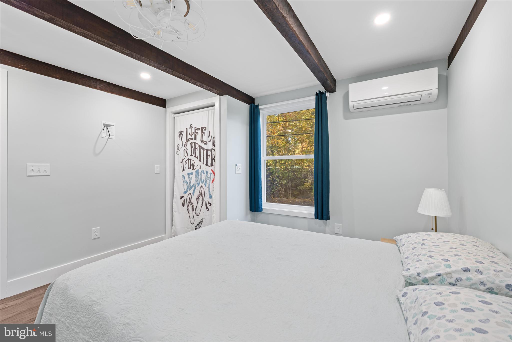 2 Bridge Road Bethany Beach, DE 19930 - Photo 29 of 65 a bedroom with a large bed and a window