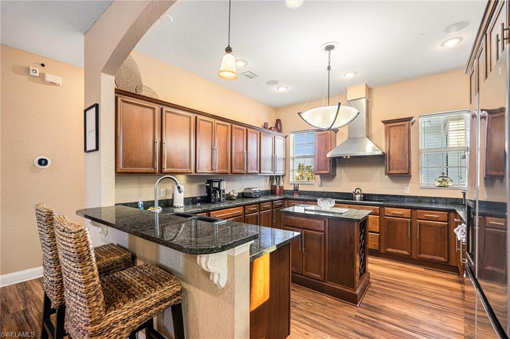 1316 Apollo Beach Boulevard South Apollo Beach, FL 33572 - Photo 13 of 47 a kitchen with stainless steel appliances granite countertop a sink a stove a counter space and dining table