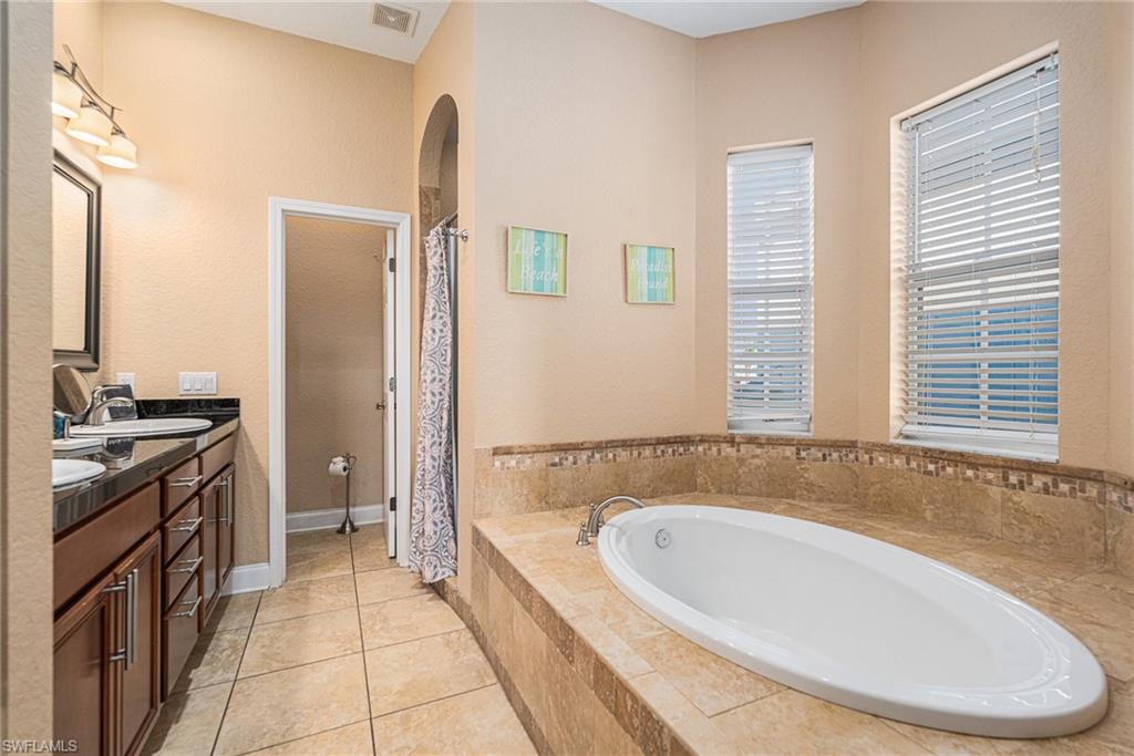 1316 Apollo Beach Boulevard South Apollo Beach, FL 33572 - Photo 18 of 47 a bathroom with a bathtub and a sink