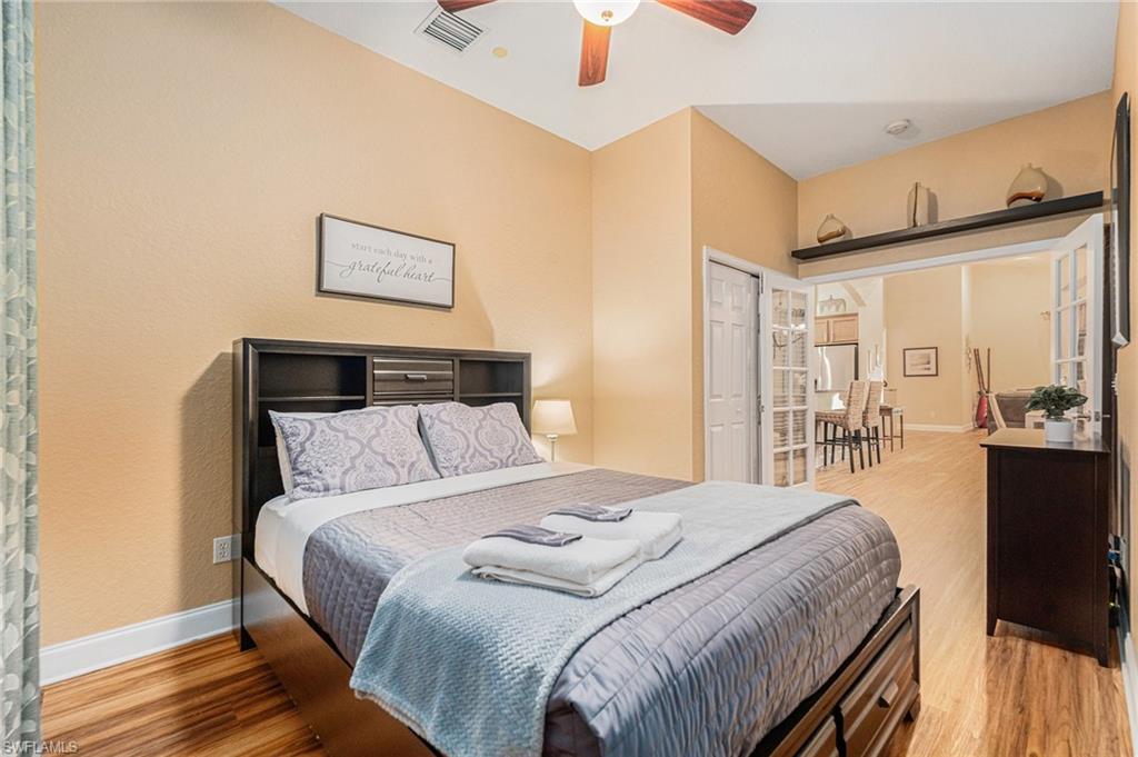 1316 Apollo Beach Boulevard South Apollo Beach, FL 33572 - Photo 22 of 47 a bedroom with a bed and a large mirror