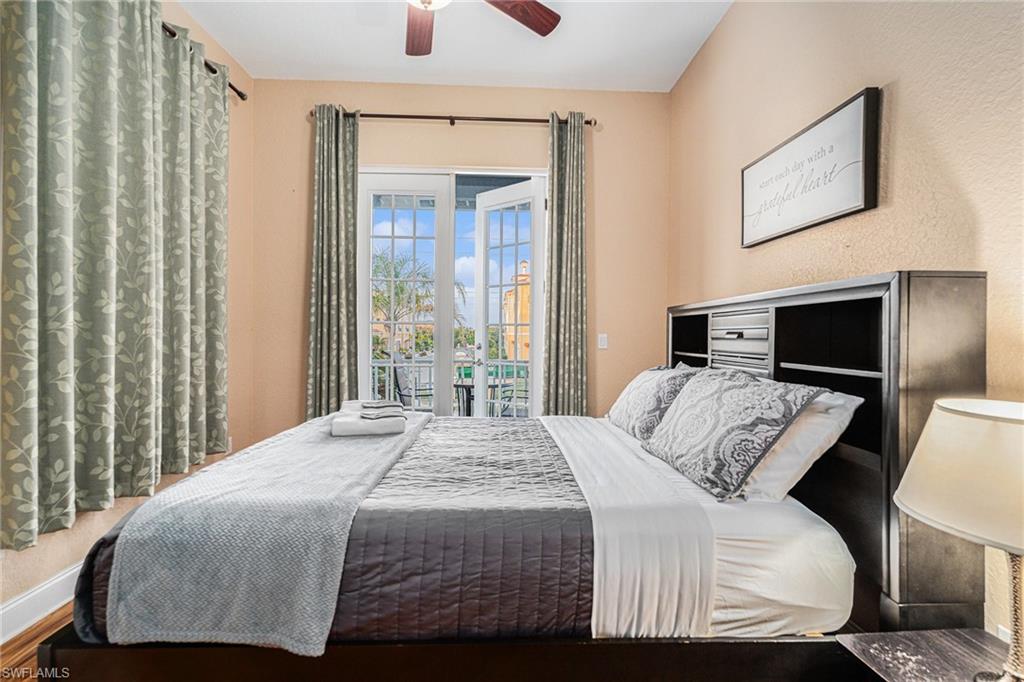 1316 Apollo Beach Boulevard South Apollo Beach, FL 33572 - Photo 23 of 47 a bedroom with a balcony a bed and a television