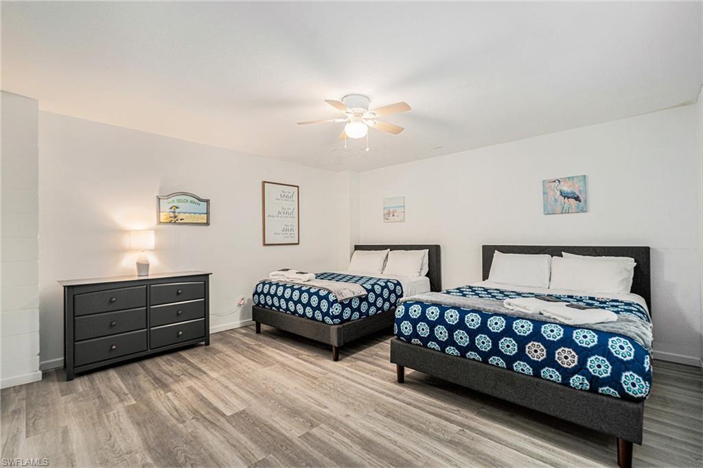 1316 Apollo Beach Boulevard South Apollo Beach, FL 33572 - Photo 32 of 47 a bedroom with two beds and painting on the wall