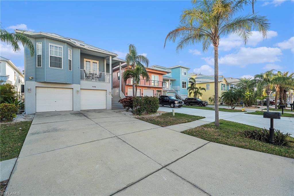 1316 Apollo Beach Boulevard South Apollo Beach, FL 33572 - Photo 47 of 47 a front view of a house with a yard and palm trees