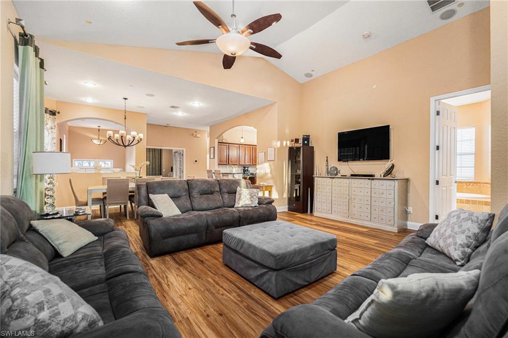 1316 Apollo Beach Boulevard South Apollo Beach, FL 33572 - Photo 9 of 47 a living room with furniture ceiling fan and a flat screen tv