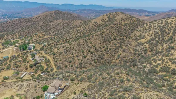 a view of a dry yard and mountain