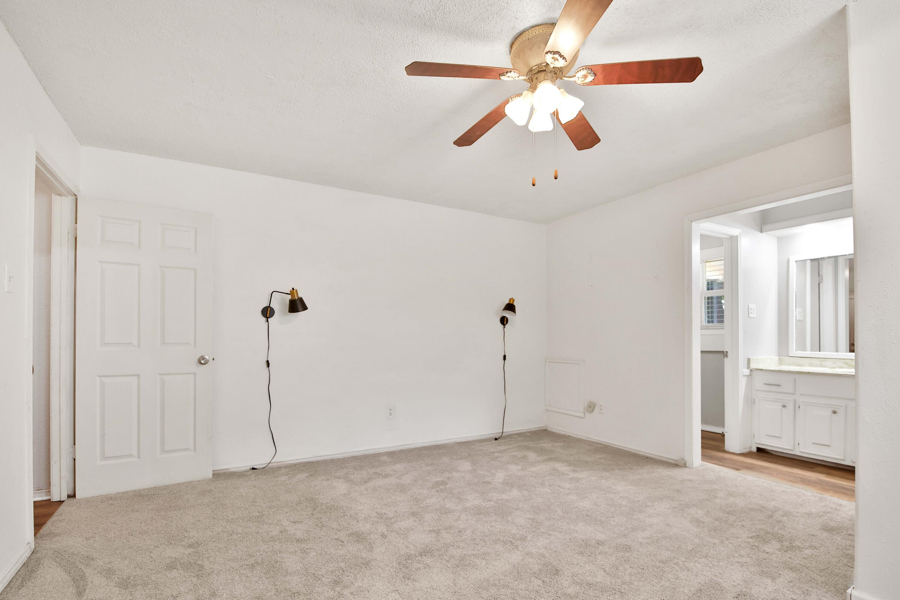 4818 73rd Street Lubbock, TX 79424 - Photo 16 of 31 a view of an empty room with a ceiling fan