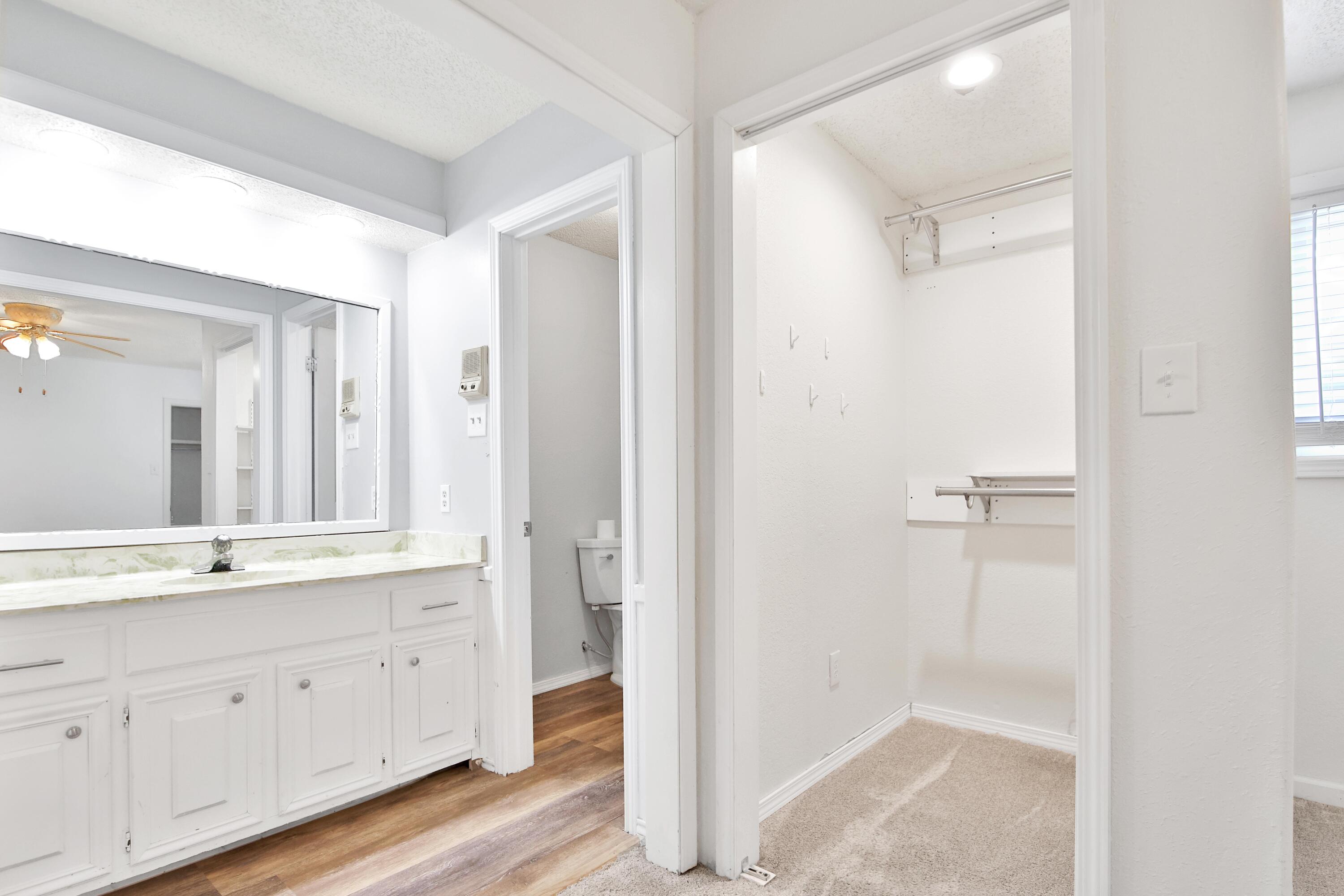 4818 73rd Street Lubbock, TX 79424 - Photo 18 of 31 a bathroom with a double vanity sink and mirror
