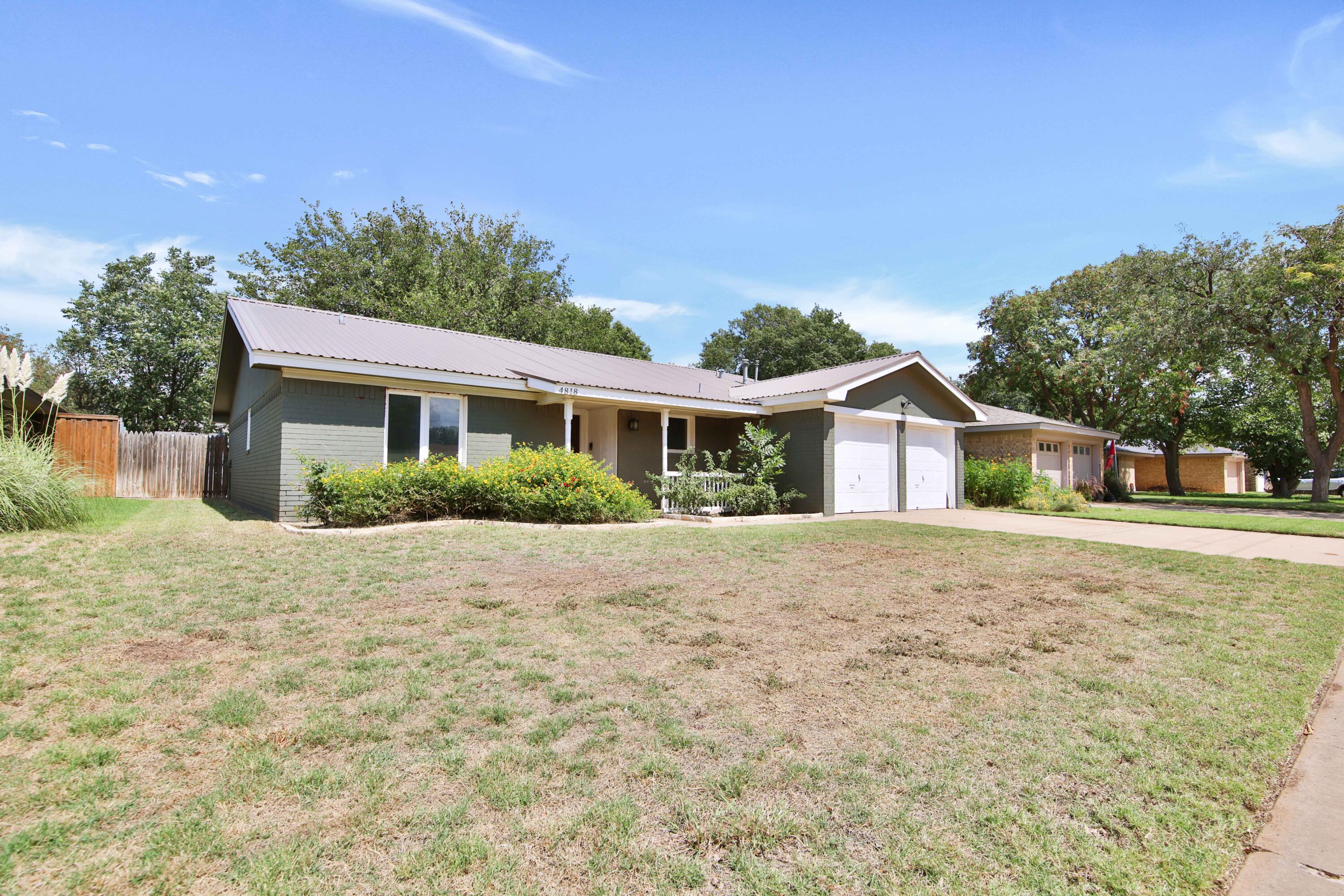 4818 73rd Street Lubbock, TX 79424 - Photo 2 of 31 a front view of a house with a yard