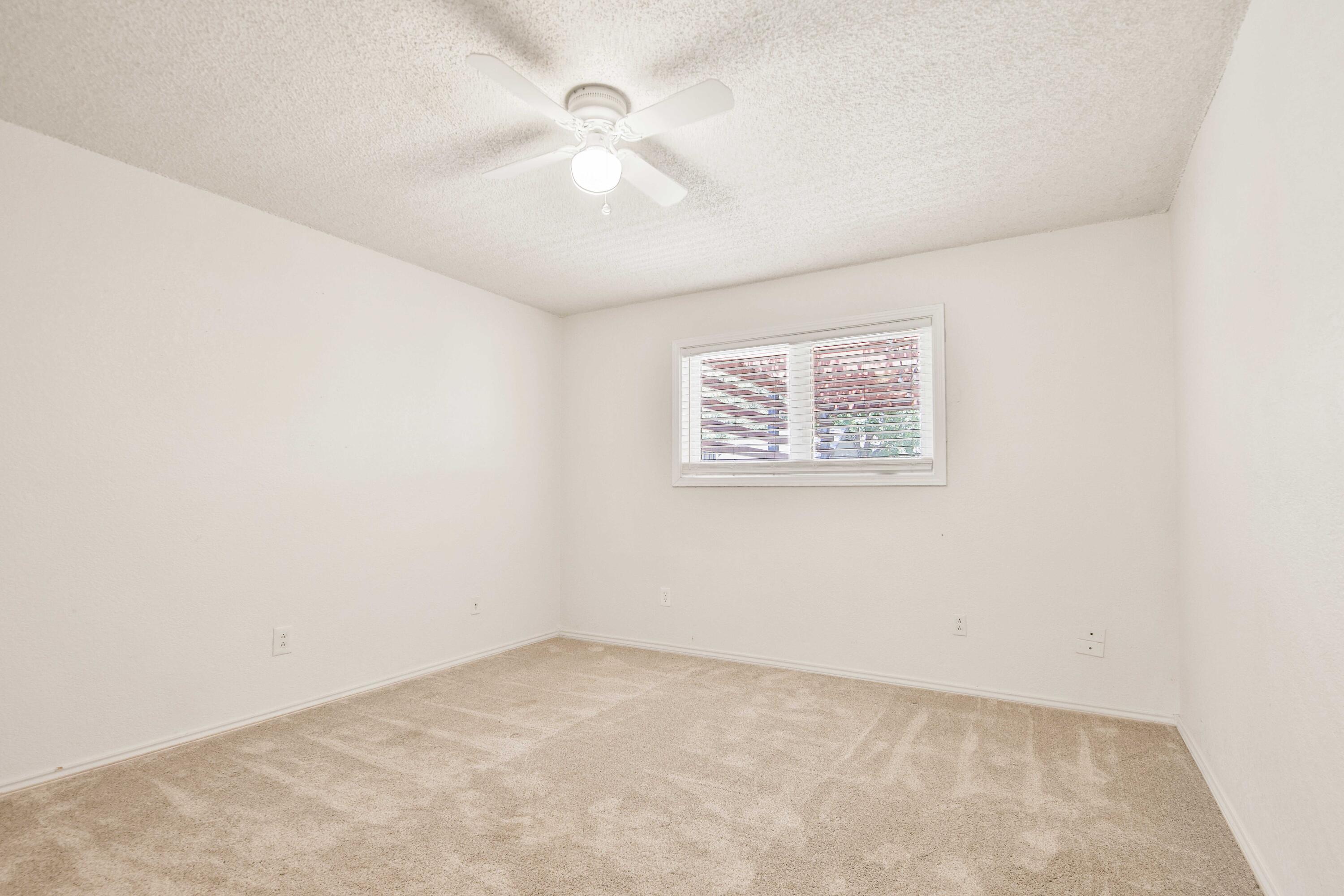 4818 73rd Street Lubbock, TX 79424 - Photo 27 of 31 an empty room with a chandelier fan