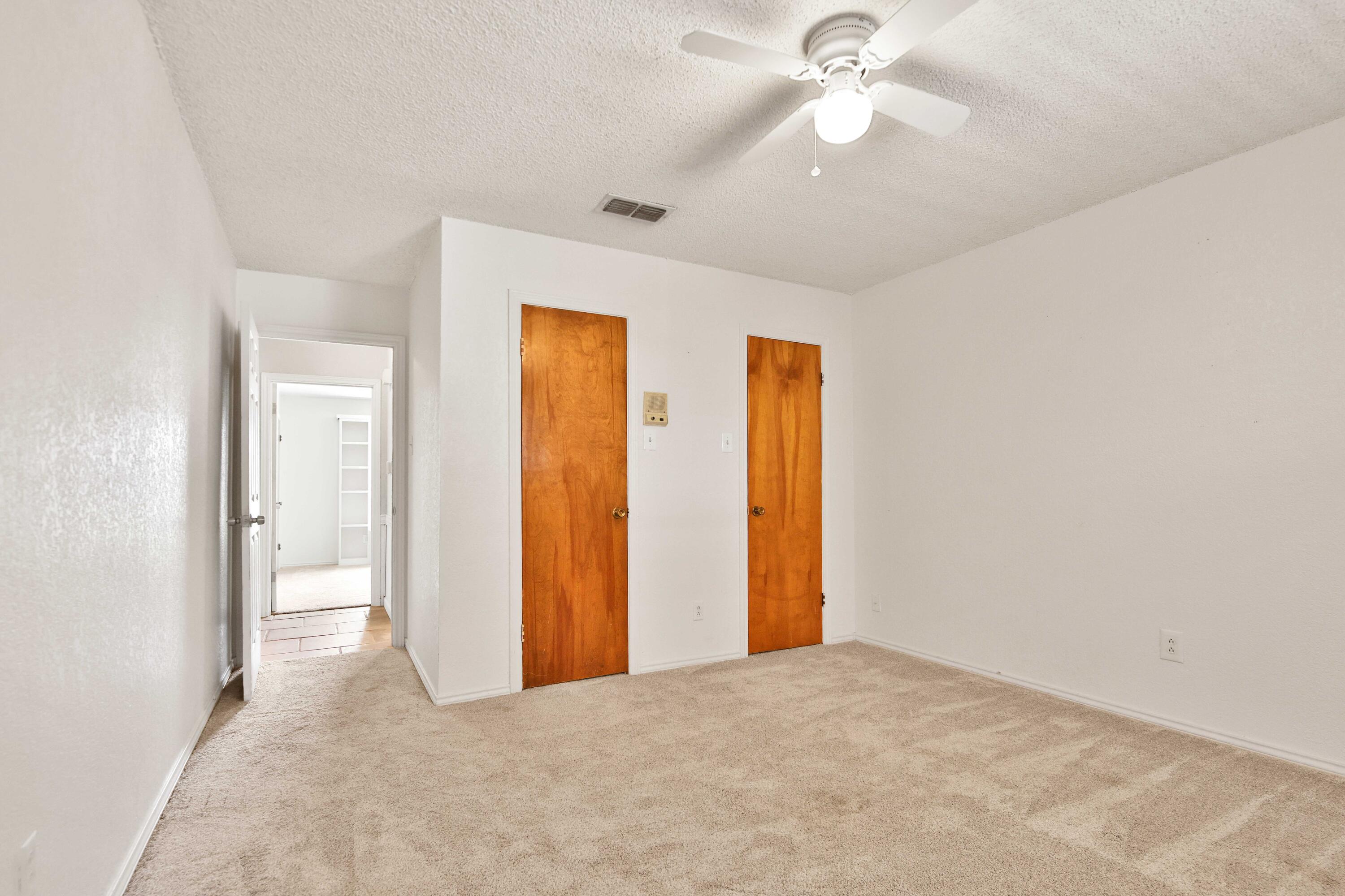 4818 73rd Street Lubbock, TX 79424 - Photo 28 of 31 an empty room with closet and a chandelier fan
