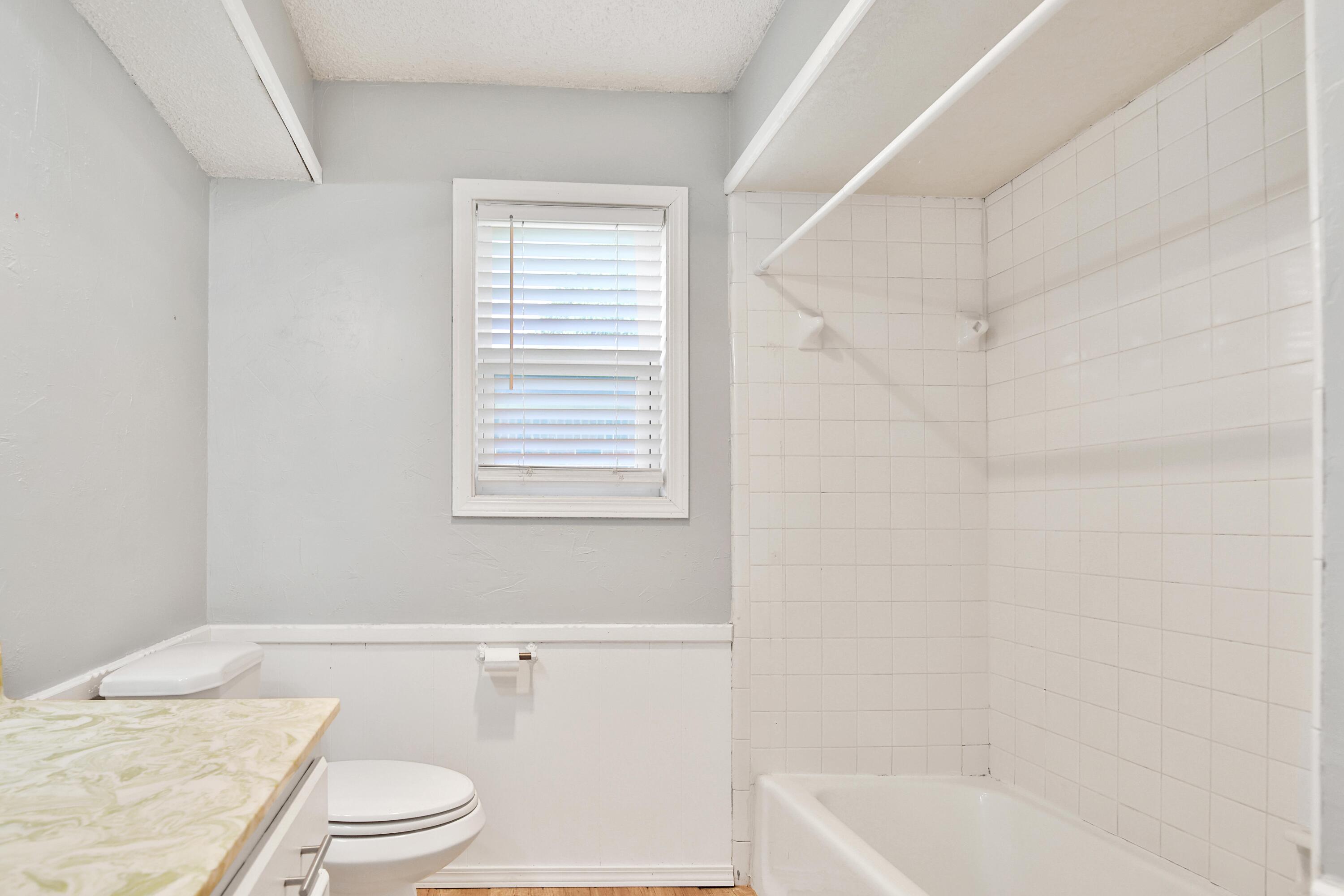 4818 73rd Street Lubbock, TX 79424 - Photo 31 of 31 a white toilet sitting next to a bath tub