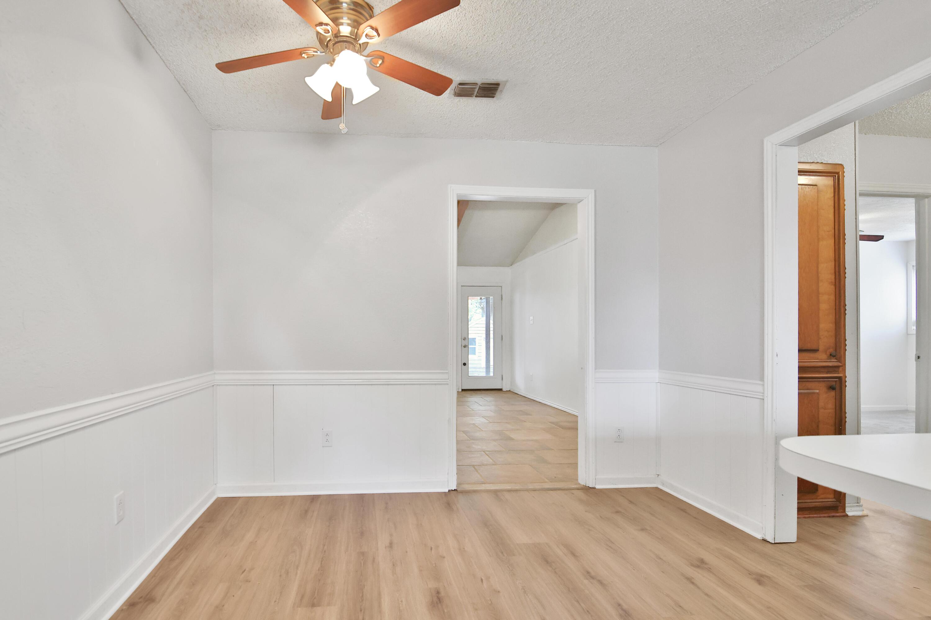 4818 73rd Street Lubbock, TX 79424 - Photo 8 of 31 wooden floor in an empty room with a window