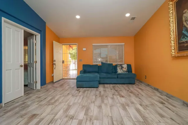 a spacious bedroom with a bed and a window