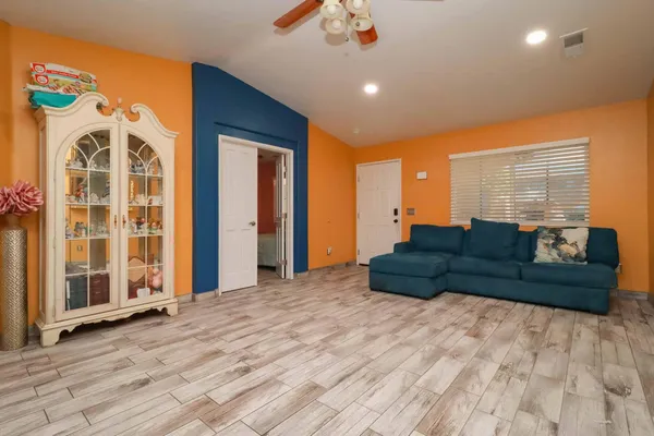 a view of a livingroom with furniture and a flat screen tv