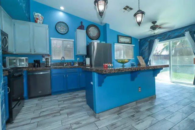 a kitchen with stainless steel appliances granite countertop a stove and cabinets