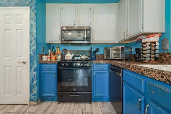 a kitchen with stainless steel appliances granite countertop a refrigerator a oven a sink and dishwasher