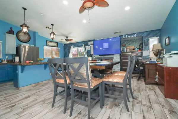 a kitchen with granite countertop a stove a sink and a wooden cabinets