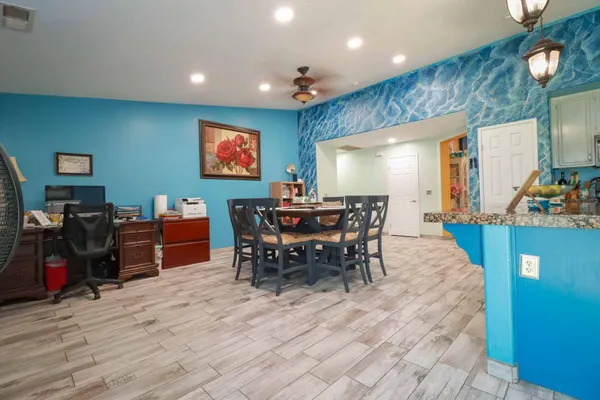 a dining room with wooden floor and a large window