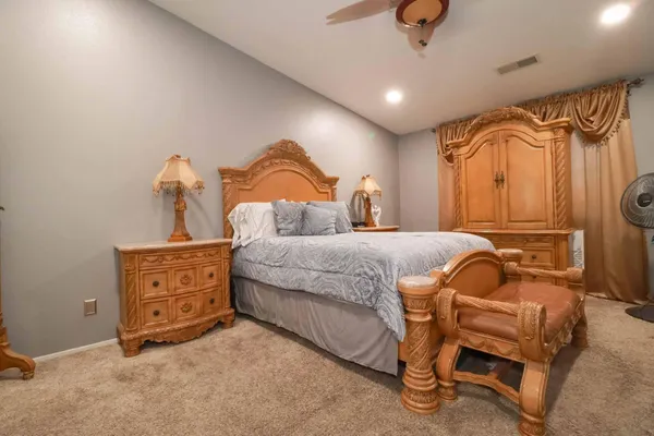 a bedroom with a bed and flat screen tv