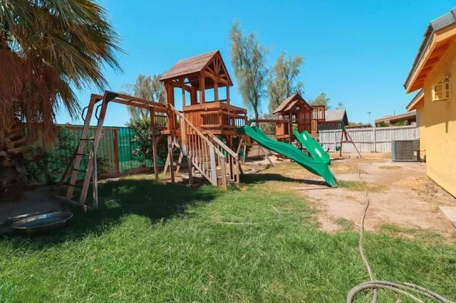 a childrens park with lots of swings and slides