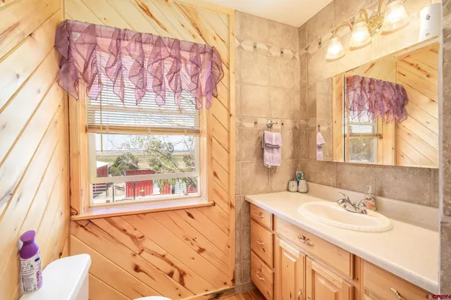 a bathroom with a toilet sink and shower