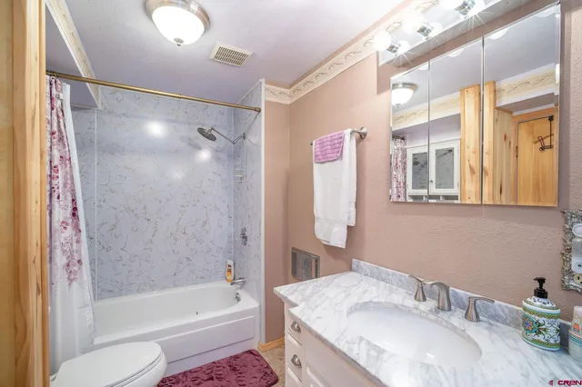 a view of a livingroom with furniture and a bathroom