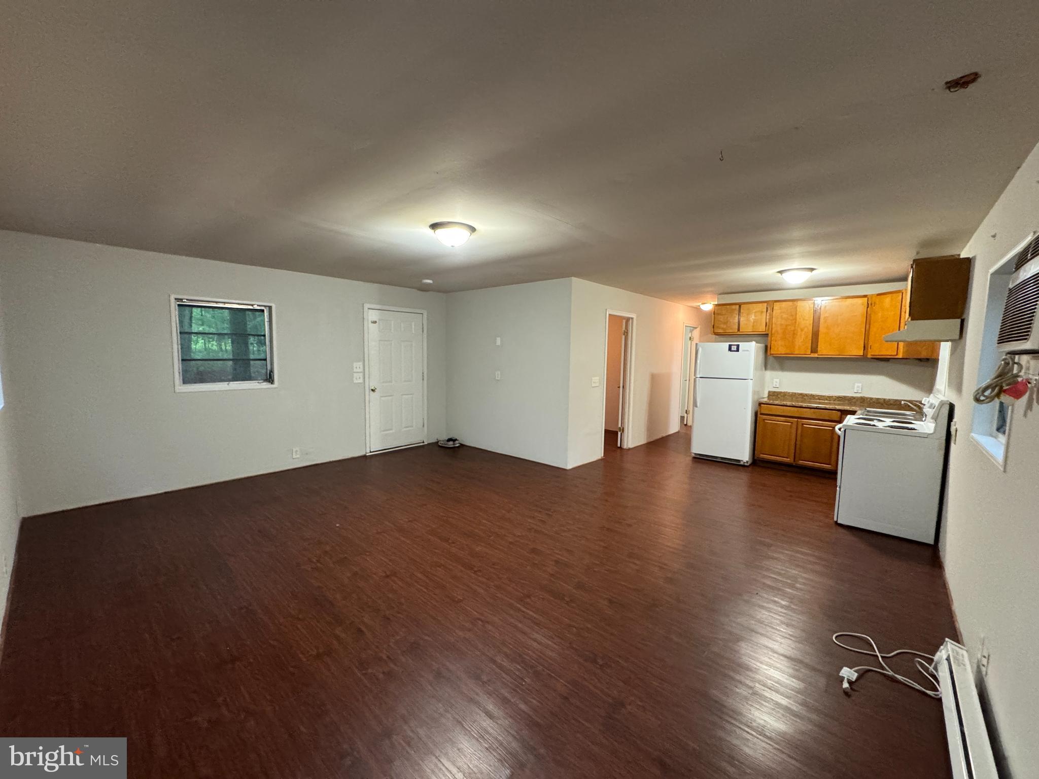 19086 Carlyle Street Ruther Glen, VA 22546 - Photo 7 of 19 an empty room with hard wood floors and furniture