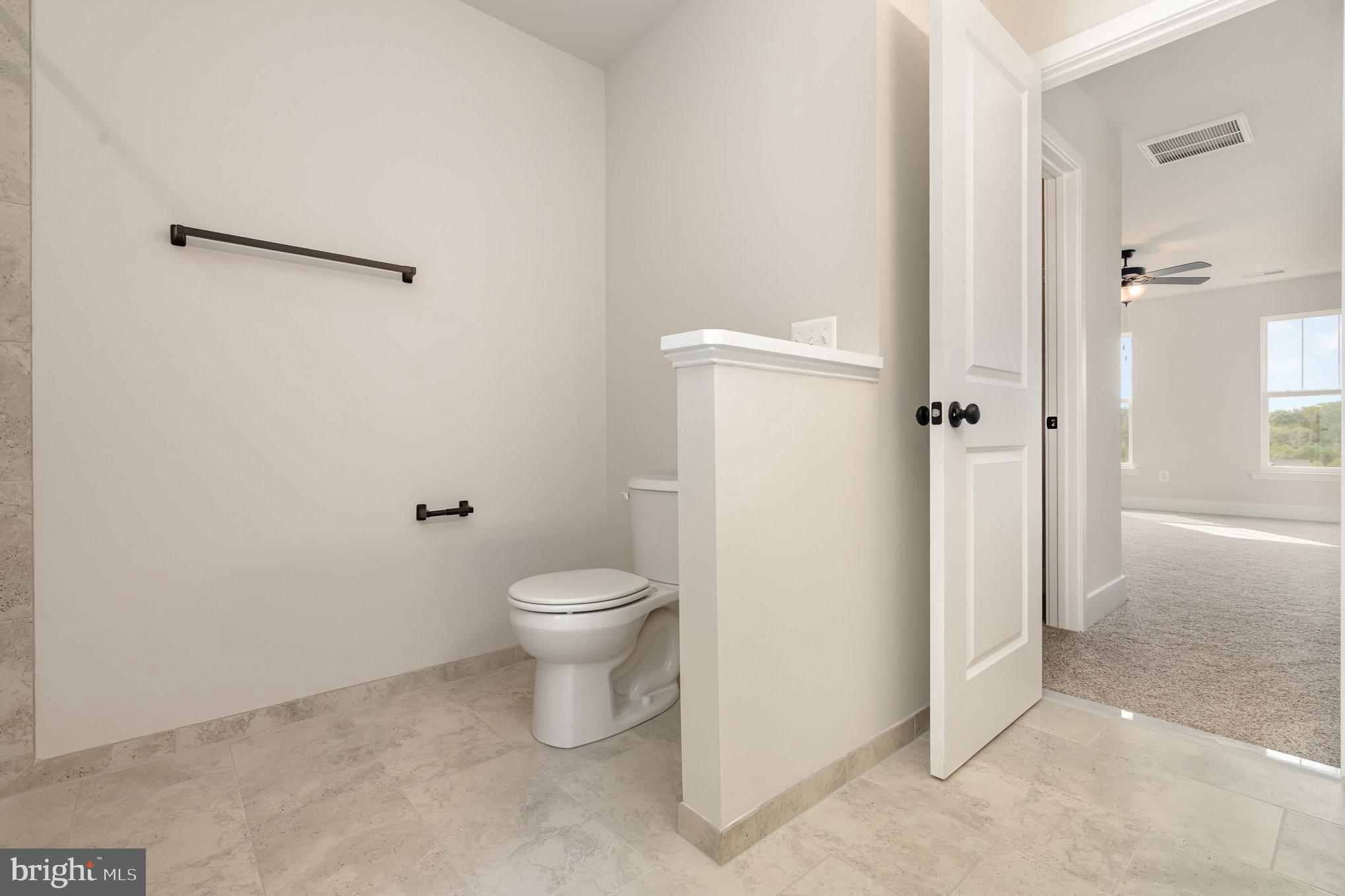 627 Rock Hill Church Road Stafford, VA 22556 - Photo 36 of 54 a white toilet sitting next to a bathroom sink